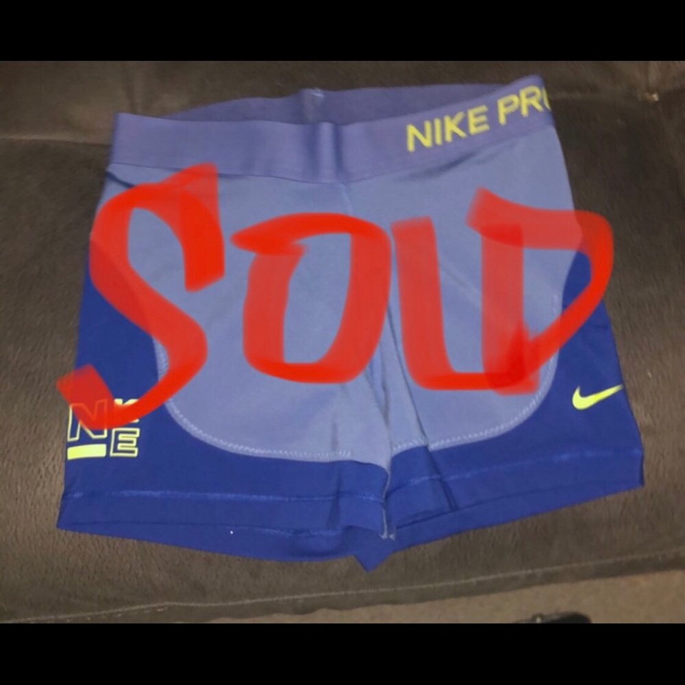 Nike Pro Shorts. Blue, light blue and neon yellow lettering. Gently used.